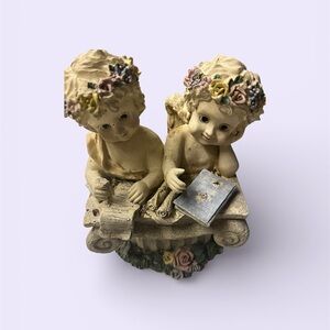 Charming Cherub Figurine with Floral Accents